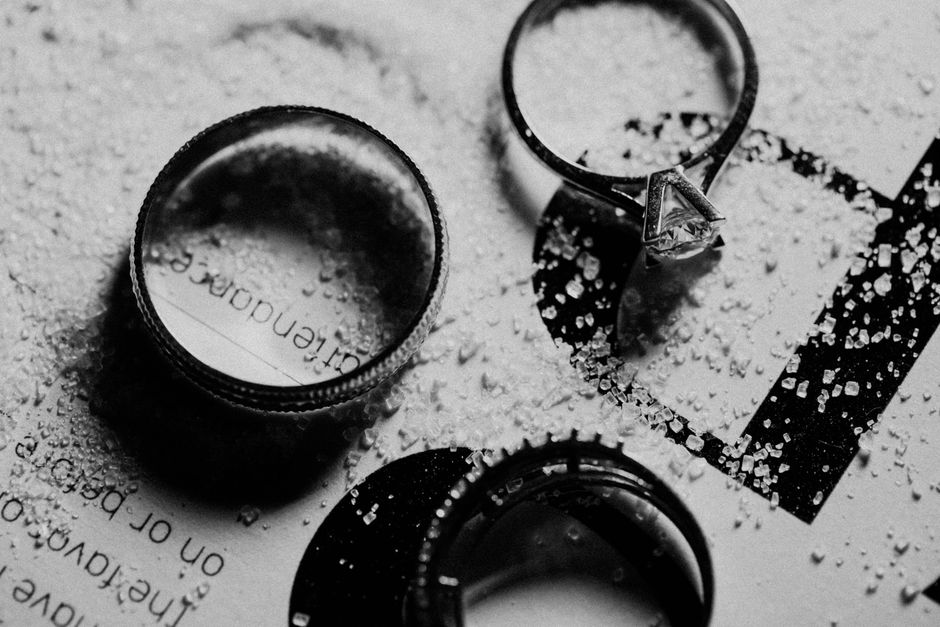 Macro shot of wedding rings highlighting engagement photos detail
